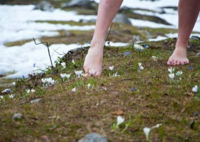 barefoot woman on green grass field